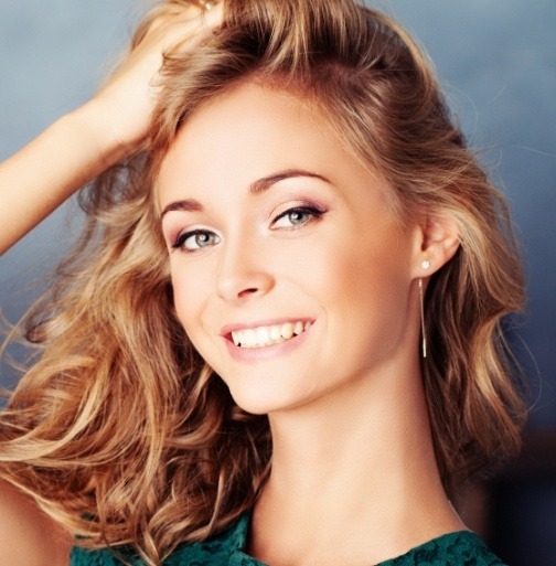 Woman with gorgeous smile after porcelain veneers