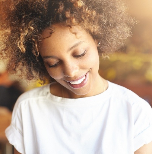 Woman with beautiful smile after metal free dental restorations