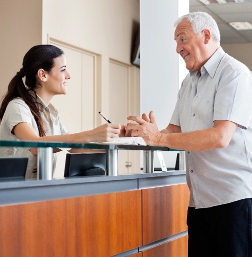 Patient discussing the cost of dental implant tooth replacement