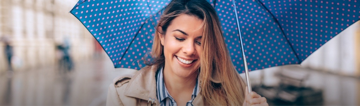 Smiling woman under an umbrella