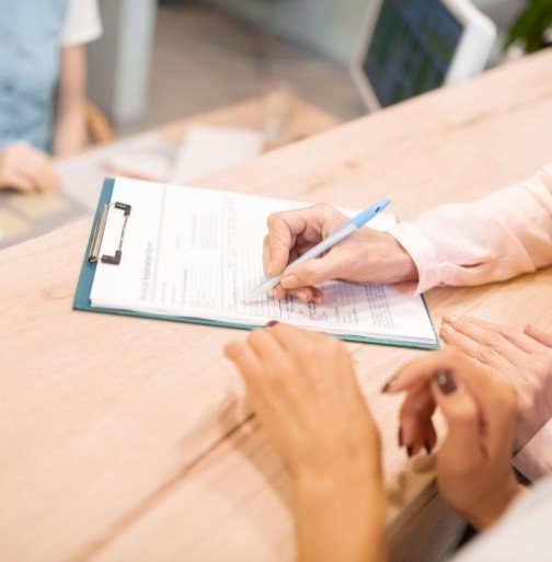 Patient completing dental insurance forms