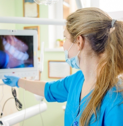Dental team member looking at images captured by intraoral camera