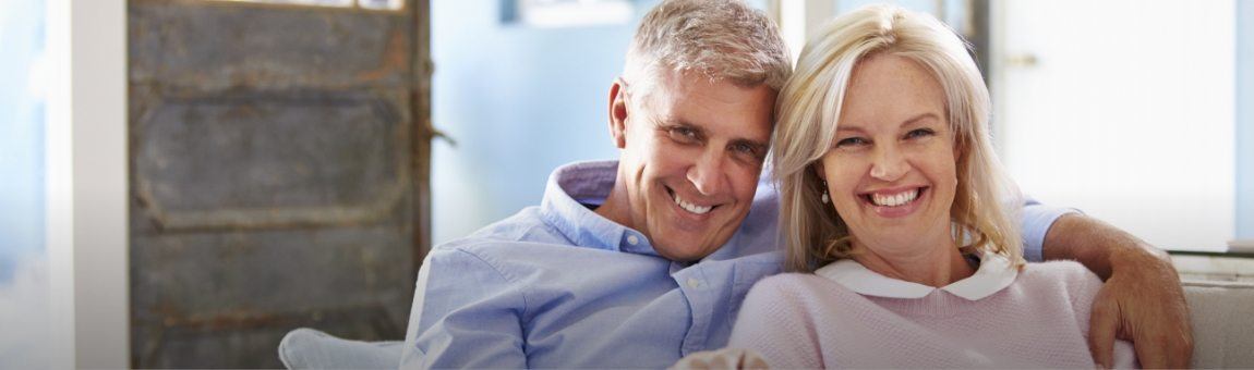 Man and woman with dentures sharing their smiles