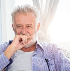Man with lost filling covering his mouth