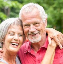 Couple smiling with dental implants in Newington