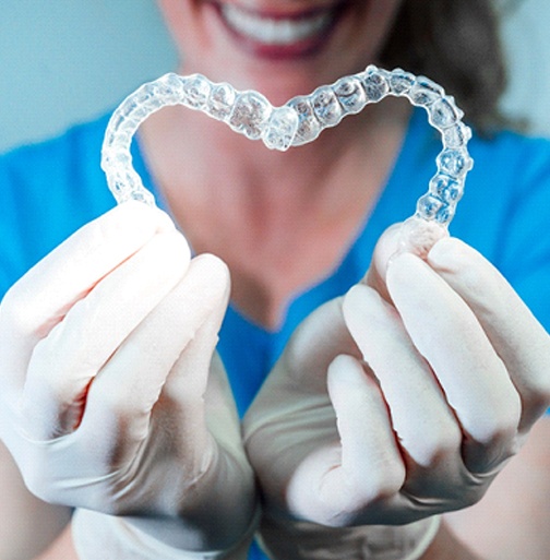 dentist making heart with two clear aligners