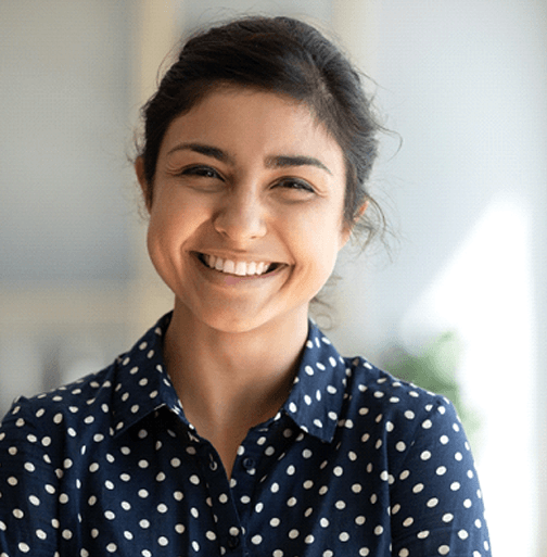 Woman in polka dot shirt smiling