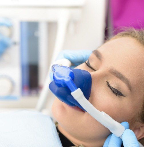 WOman receiving treatment under nitrous oxide dental sedation
