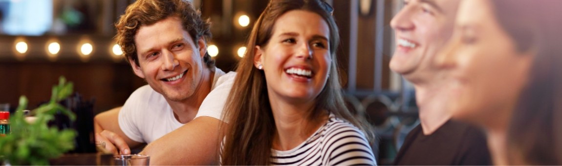 Group of friends laughing together after dental services