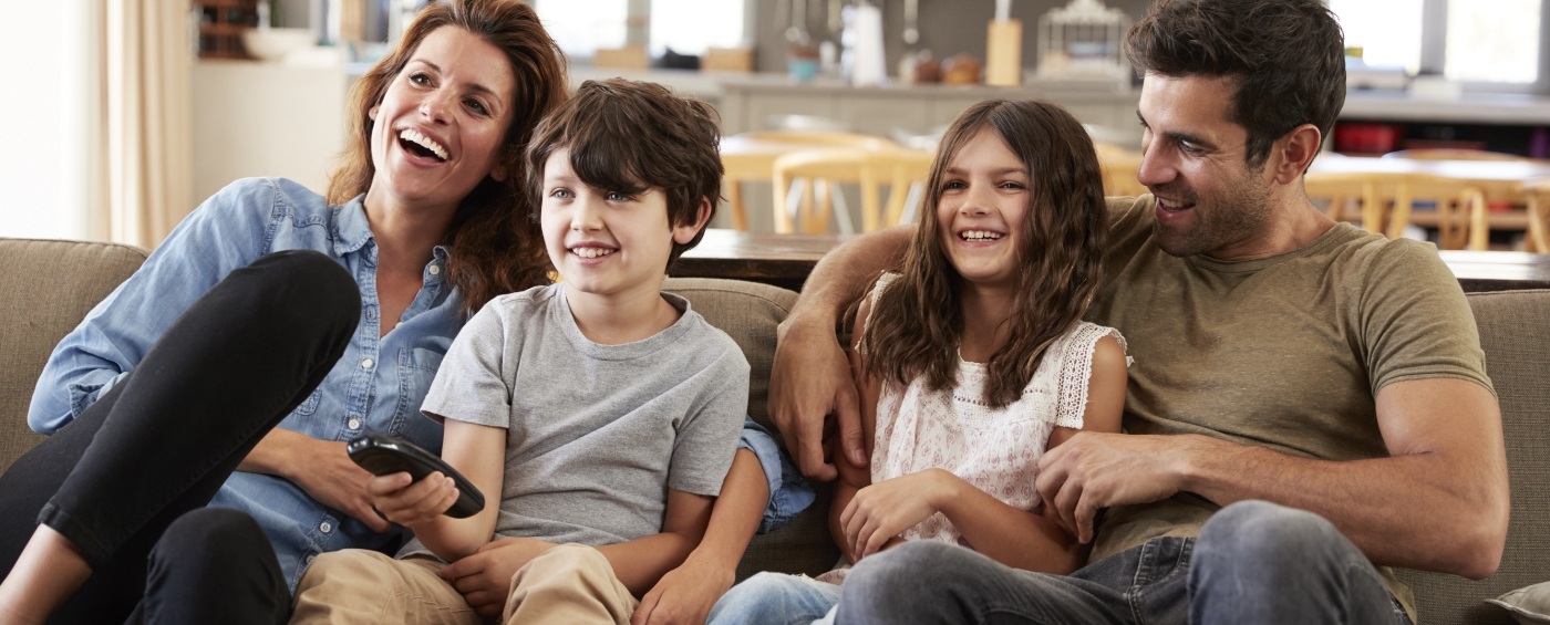 Family smiling together after preventive dentistry