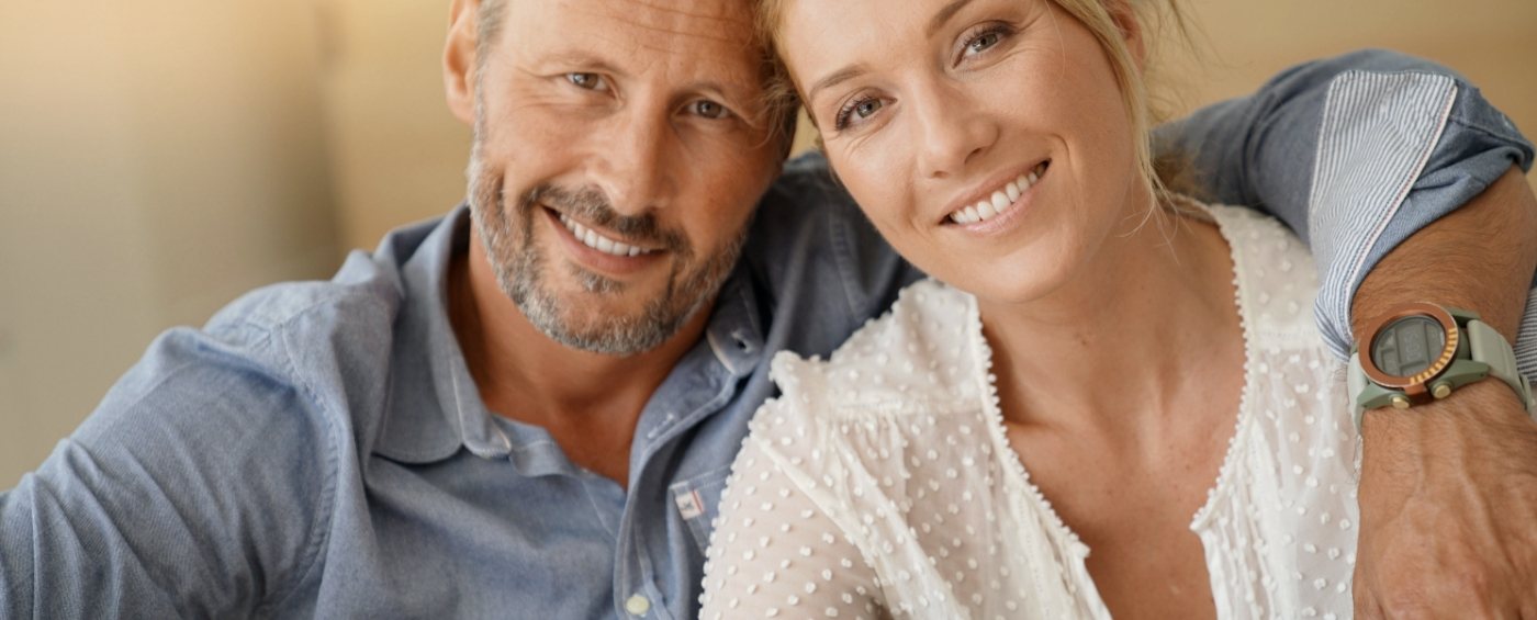 Man and woman with healthy smiles after cosmetic dentistry