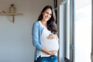 Pregnant woman smiling happily