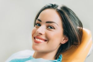 Woman smiling happily in dental chair