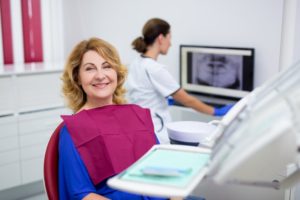 Woman smiling while sitting in the dental chair