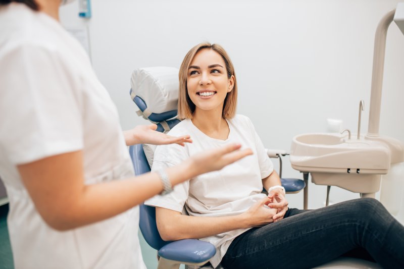 patient speaking to dentist at dental implant consultation