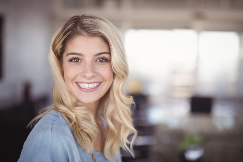 person who had dental implant surgery smiling