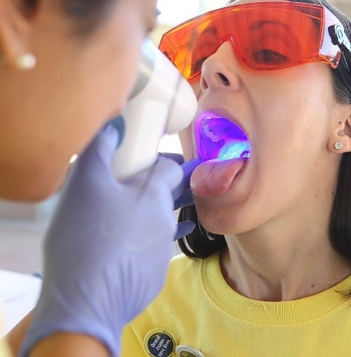 Dentist performing an oral cancer screening